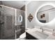 Modern bathroom features a sleek glass shower, contemporary vanity, and stylish lighting for a spa-like experience at 12927 Woodridge Dr, Longmont, CO 80504