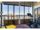 A brightly lit balcony with cityscape views, a Peloton bike, and a cozy seating area with a colorful rug at 800 N Pearl St # 1207, Denver, CO 80203