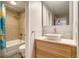 Bathroom featuring modern fixtures, including a vessel sink, a stylish vanity, and a tiled shower with a glass door at 800 N Pearl St # 1207, Denver, CO 80203