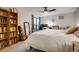 Bright bedroom featuring a ceiling fan, a bookshelf, and a workspace with a view from the balcony at 800 N Pearl St # 1207, Denver, CO 80203