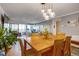 Open-concept dining room with modern lighting fixtures and views into the living room and balcony at 800 N Pearl St # 1207, Denver, CO 80203