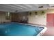 Bright indoor pool area featuring hanging plants, lounge chairs, and pool safety signs at 800 N Pearl St # 1207, Denver, CO 80203