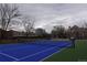 Outdoor blue tennis court with net and residential buildings in the background at 800 N Pearl St # 1207, Denver, CO 80203