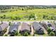 Aerial view of houses with a neighborhood park and windmill in the distance at 24028 E Caleb Pl, Aurora, CO 80016