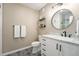 Charming bathroom with decorative tile floor, modern fixtures, and a circular mirror at 24028 E Caleb Pl, Aurora, CO 80016
