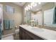 Bathroom with a double sink vanity, a large mirror, and a shower tub at 24028 E Caleb Pl, Aurora, CO 80016