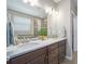 Bathroom with double vanity, neutral walls, large mirror and tiled shower at 24028 E Caleb Pl, Aurora, CO 80016