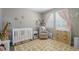 Bedroom with crib, changing table, glider, and modern designed rug at 24028 E Caleb Pl, Aurora, CO 80016