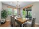 Dining room features a wooden table, comfortable seating, and views of the outdoor patio at 24028 E Caleb Pl, Aurora, CO 80016
