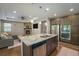 Open kitchen with granite island, stainless appliances overlooking a living room with a fireplace at 24028 E Caleb Pl, Aurora, CO 80016