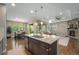 Open concept kitchen with granite island, stainless appliances, and an adjacent living and dining area at 24028 E Caleb Pl, Aurora, CO 80016
