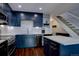 Updated kitchen with dark cabinetry, stainless steel appliances, and a bright, inviting atmosphere near staircase at 8354 S Everett Way # C, Littleton, CO 80128