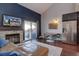 Open-concept living room featuring a fireplace, TV, seamless flow into kitchen and dining area with backyard view at 8354 S Everett Way # C, Littleton, CO 80128