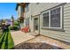 Backyard featuring a patio with two chairs, a lawn, rocks and the exterior of the home at 13020 Grant W Cir # A, Thornton, CO 80241