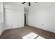 Spacious bedroom featuring a ceiling fan, carpeted floor, and double door closet at 13020 Grant W Cir # A, Thornton, CO 80241