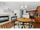Dining area featuring a dining table with seating for four, a chandelier, and dark wood flooring at 13020 Grant W Cir # A, Thornton, CO 80241