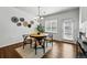Bright dining room featuring a chandelier, hardwood floors and modern decor at 13020 Grant W Cir # A, Thornton, CO 80241