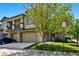 Charming townhome featuring a two-car garage, beautiful landscaping, and stone accents at 13020 Grant W Cir # A, Thornton, CO 80241