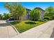 Well-maintained townhome with lush green lawn, trees, and a two-car garage at 13020 Grant W Cir # A, Thornton, CO 80241