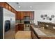 Well lit kitchen with stainless steel appliances, tile flooring and granite countertops at 13020 Grant W Cir # A, Thornton, CO 80241