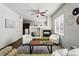 Cozy living room featuring a fireplace, ceiling fan, and two comfortable armchairs at 13020 Grant W Cir # A, Thornton, CO 80241