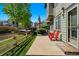 Relaxing patio space with two red chairs, perfect for outdoor enjoyment at 13020 Grant W Cir # A, Thornton, CO 80241