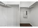 Empty walk-in closet with metal clothing racks and white walls at 13020 Grant W Cir # A, Thornton, CO 80241