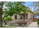 Tan brick house with a covered porch and stone accents at 2250 N Hooker St, Denver, CO 80211