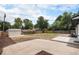 A spacious backyard, a blank canvas for landscaping and outdoor enjoyment, featuring a new shed and concrete patio at 530 Everett St, Lakewood, CO 80226