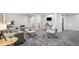 Open basement layout showcasing a cozy living area with comfortable seating and neutral gray carpet at 530 Everett St, Lakewood, CO 80226