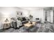 Basement living room with gray sofa, stylish accents, and gray carpet flooring at 530 Everett St, Lakewood, CO 80226