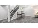 View of the basement stairs and lounge area with modern decor and gray carpet flooring at 530 Everett St, Lakewood, CO 80226