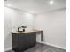 Modern basement bar area with dark wood cabinets and countertop with a view of recessed lights at 530 Everett St, Lakewood, CO 80226
