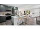 Open-concept kitchen with stainless appliances, island seating, and seamless flow into living areas at 530 Everett St, Lakewood, CO 80226