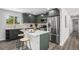 Modern kitchen with stainless appliances, sleek cabinets, and stylish center island with seating at 530 Everett St, Lakewood, CO 80226