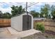 A storage shed with concrete foundation and double doors sits in the backyard at 530 Everett St, Lakewood, CO 80226