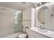 Bright bathroom includes a shower-tub combo with sliding door and modern vanity at 3480 S Eagle St # 101, Aurora, CO 80014