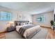 Serene bedroom with a large window, hardwood floors, and a comfortable king-size bed at 3480 S Eagle St # 101, Aurora, CO 80014
