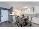 Charming dining area with sleek black table set for 6, opening to a modern kitchen at 3480 S Eagle St # 101, Aurora, CO 80014