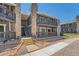 Attractive condo exterior with two-story design, stone accents, and inviting stairwell at 3480 S Eagle St # 101, Aurora, CO 80014