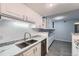 Kitchen featuring stainless steel sink, marble countertops, and bright cabinetry at 3480 S Eagle St # 101, Aurora, CO 80014