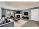 Inviting living room featuring a fireplace, gray walls, and modern decor and balcony access at 3480 S Eagle St # 101, Aurora, CO 80014