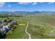 Aerial view showcasing the homes proximity to walking trails, neighborhood, and the mountains at 2640 Overlook Dr, Broomfield, CO 80020