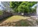 Private backyard featuring green grass, mature trees, and a wood fence at 2640 Overlook Dr, Broomfield, CO 80020