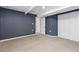 Unfinished basement featuring carpeted flooring, blue accent wall, and white doors at 2640 Overlook Dr, Broomfield, CO 80020