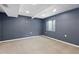 Unfinished basement featuring carpeted flooring, a window, and blue accent wall at 2640 Overlook Dr, Broomfield, CO 80020