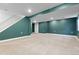 Unfinished basement with carpeted floor, green accent wall and stairs leading to the upper level at 2640 Overlook Dr, Broomfield, CO 80020