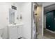 Bathroom features a vanity, mirror, tiled shower with a shower curtain, and toilet at 2640 Overlook Dr, Broomfield, CO 80020