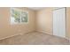 Bright bedroom with a window bringing in natural light and a closet for storage at 2640 Overlook Dr, Broomfield, CO 80020
