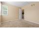 Bedroom featuring neutral walls and carpet, with large window and closet at 2640 Overlook Dr, Broomfield, CO 80020